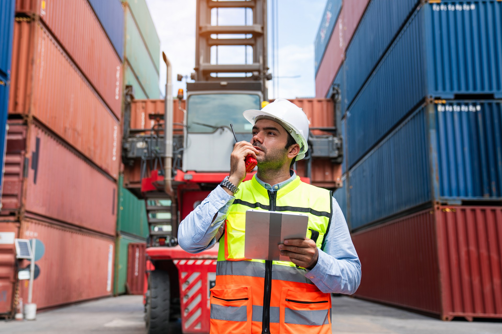 Male Container yard worker control and checking container.